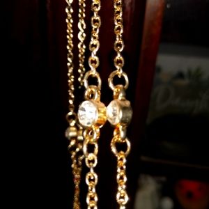 Long gold-tone necklace with rhinestone studs